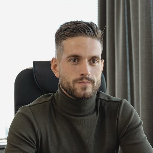 Home Businessman with a thoughtful expression sitting at a desk in a modern office.