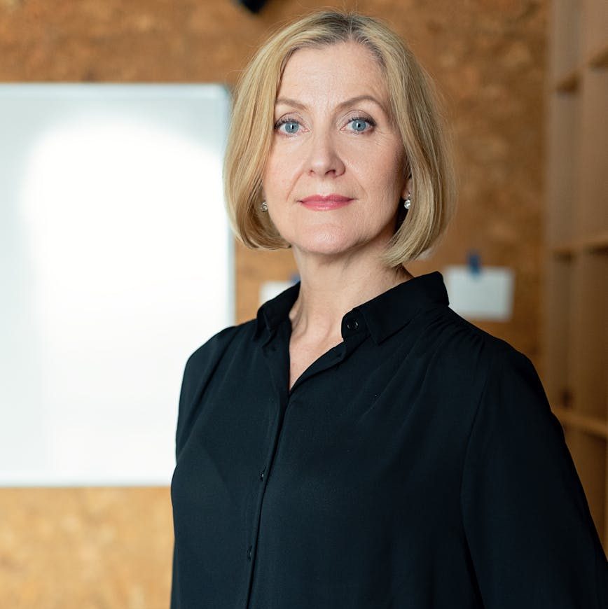 Home Confident mature businesswoman in office attire posing confidently indoors.